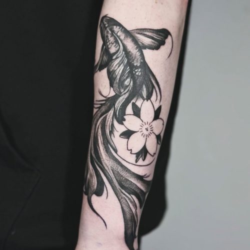 Fish and flower tattoo on forearm.