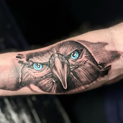 Bird with blue eyes tattoo