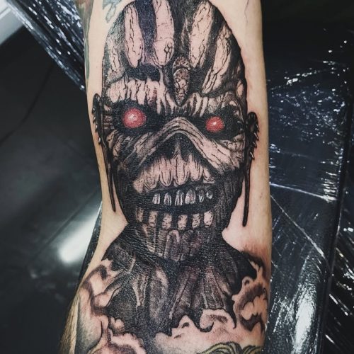 Creepy blackwork iron maiden tattoo.