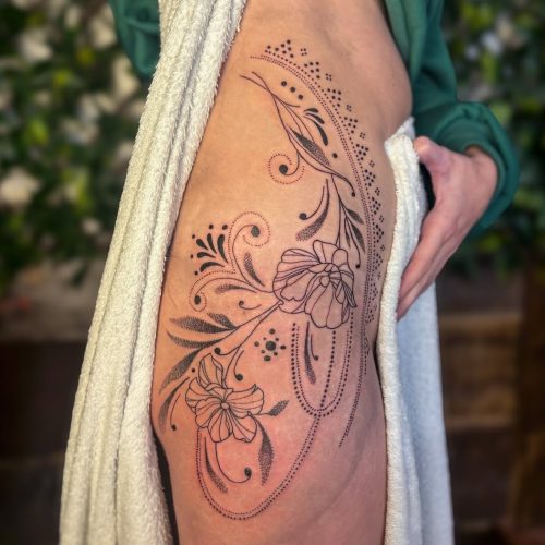 Fine line thigh tattoo