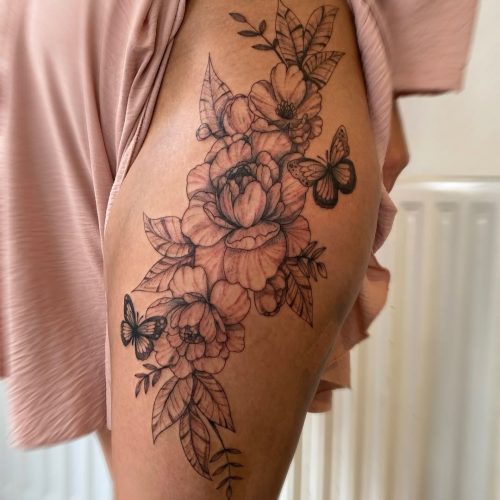 Fine line floral thigh tattoo design