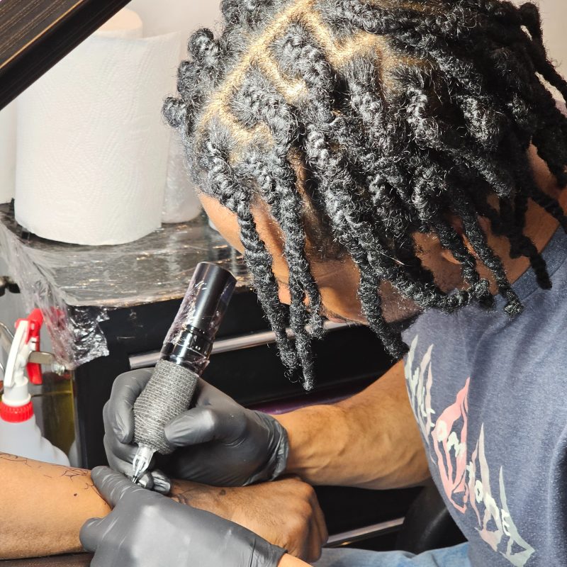Praise, a junior tattoo artist